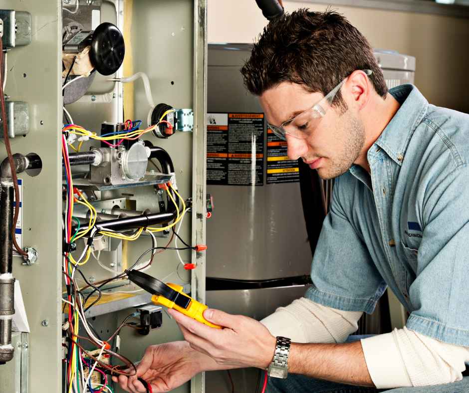 A repairman working on a furnace