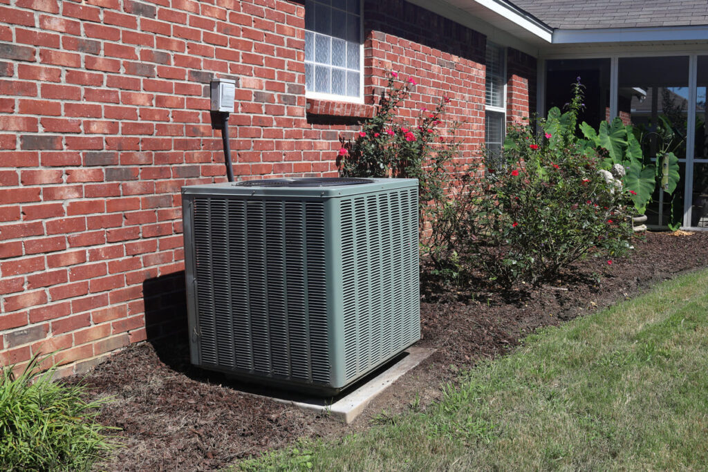 Residential AC Unit Next to Brick Home