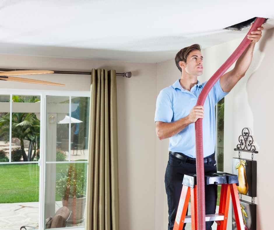 A man cleaning duct vents