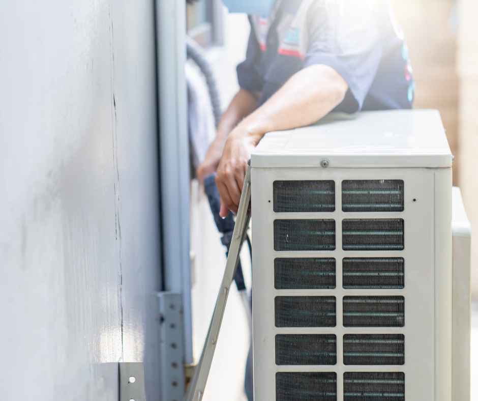 A man working on an AC unit