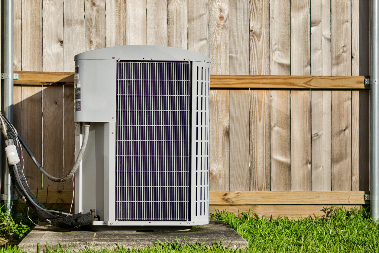 AC Unit Against Wood Fence